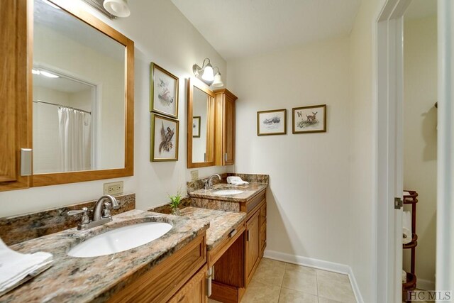 bathroom featuring vanity, a shower with curtain, and tile patterned floors