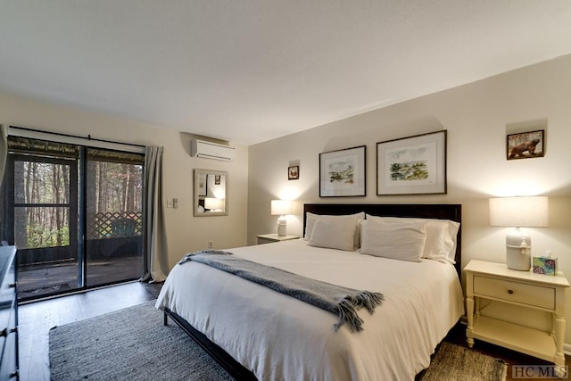 bedroom featuring dark hardwood / wood-style floors, a wall mounted AC, and access to exterior