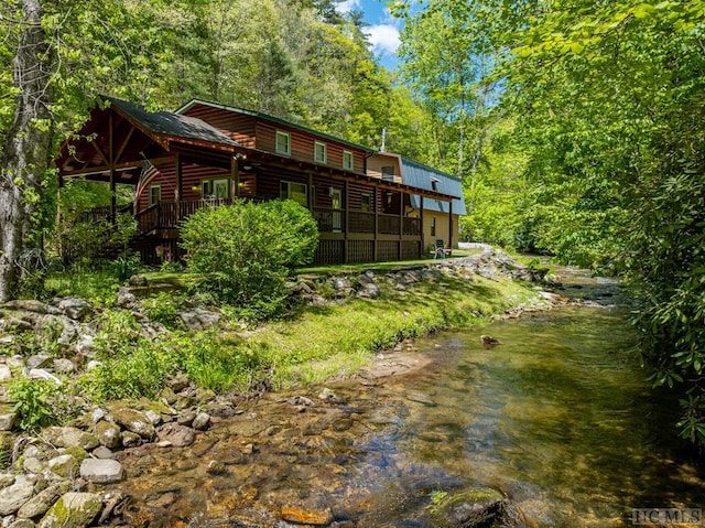 2177 Buck Creek Rd, Highlands, NC 28741 - rear view of house with log veneer siding and a wooded view