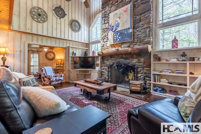 920 Sapphire Post Office Rd, Cashiers, NC 28774 - living room featuring wood finished floors, a towering ceiling, healthy amount of natural light, ceiling fan, and a fireplace