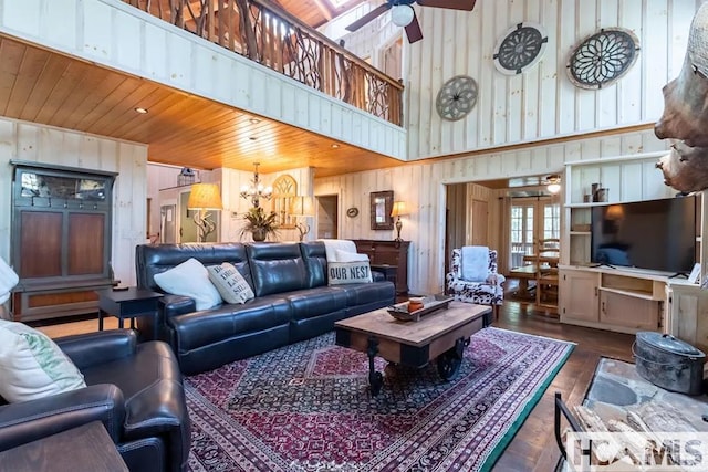 920 Sapphire Post Office Rd, Cashiers, NC 28774 - living room with ceiling fan, wood walls, a chandelier, a high ceiling, and wood finished floors