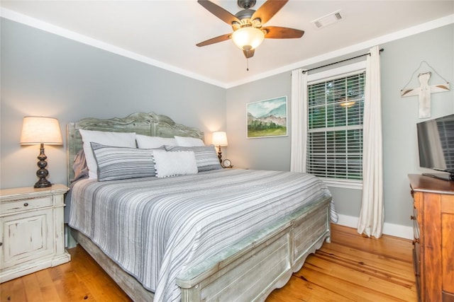 bedroom featuring crown molding, ceiling fan, and light hardwood / wood-style flooring