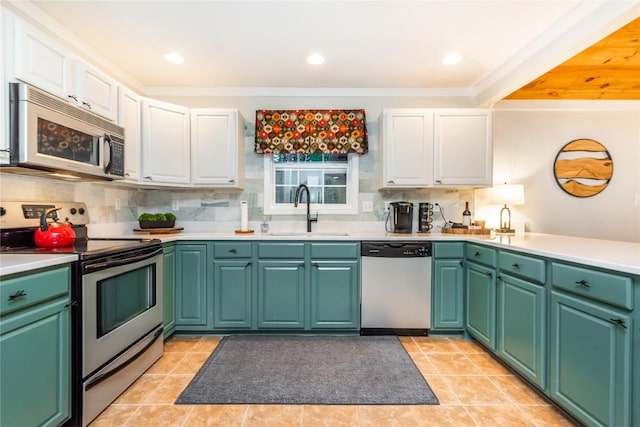 kitchen with stainless steel appliances, white cabinetry, sink, and light tile patterned flooring