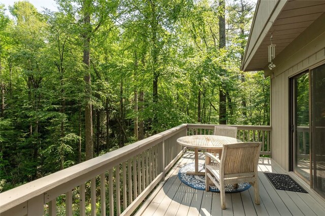 47 Red Bud Ct, Sapphire, NC 28774 - wooden deck featuring outdoor dining area and a view of trees
