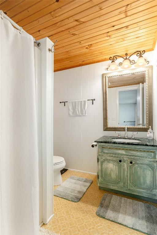 47 Red Bud Ct, Sapphire, NC 28774 - full bathroom featuring wooden ceiling, toilet, vanity, baseboards, and a shower with curtain