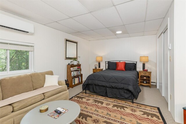 47 Red Bud Ct, Sapphire, NC 28774 - bedroom with a wall mounted AC, a drop ceiling, light colored carpet, and a baseboard radiator
