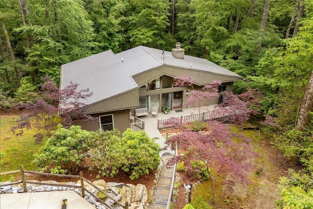 47 Red Bud Ct, Sapphire, NC 28774 - view of front of home with a chimney, a forest view, stairway, and covered porch