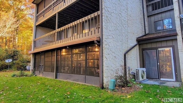 back of property with a yard and ac unit