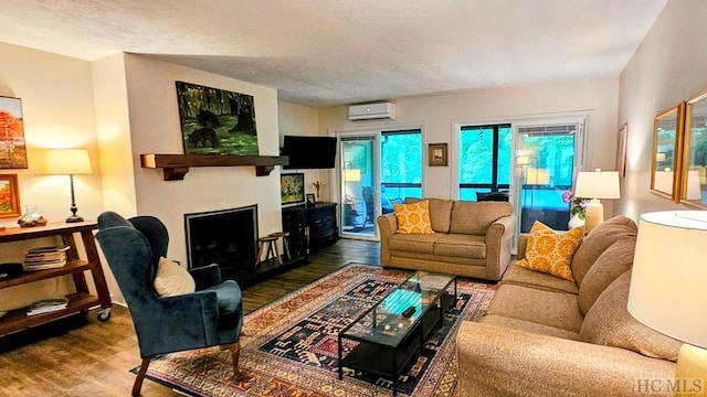 living room featuring a wall mounted AC and a textured ceiling