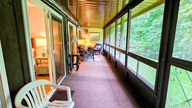 unfurnished sunroom with wood ceiling