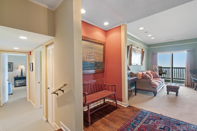 corridor featuring crown molding and light hardwood / wood-style flooring