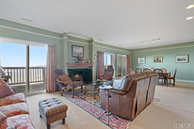 living room featuring light carpet, crown molding, and plenty of natural light