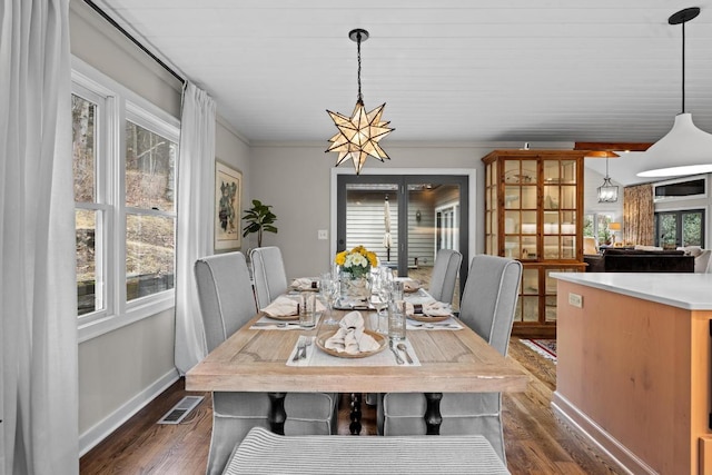 dining space featuring visible vents, plenty of natural light, and dark wood-style flooring