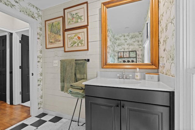 bathroom featuring tile patterned floors, vanity, and wallpapered walls