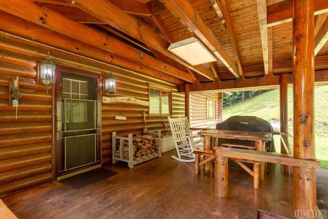 exterior space featuring wood ceiling and lofted ceiling with beams