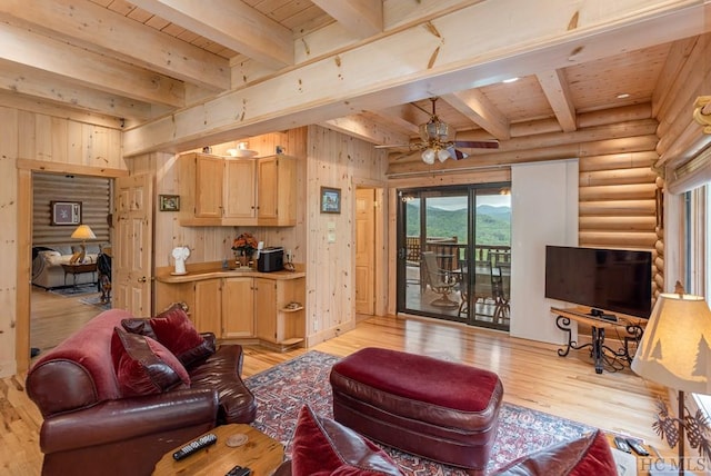 living room featuring beamed ceiling, light hardwood / wood-style floors, wooden ceiling, and rustic walls