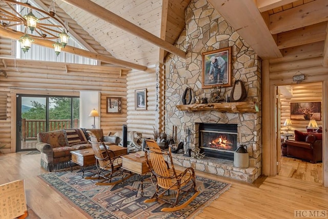 living room featuring high vaulted ceiling, a fireplace, log walls, beamed ceiling, and light wood-type flooring