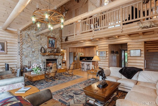 living room with a stone fireplace, high vaulted ceiling, wood-type flooring, rustic walls, and wooden ceiling