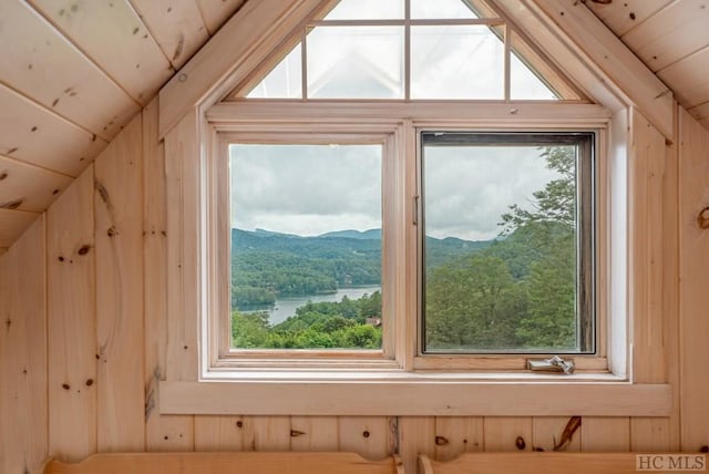 room details featuring a water and mountain view and wooden ceiling