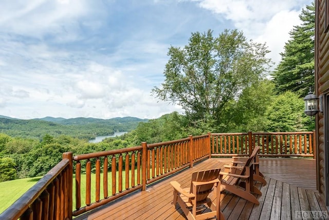 wooden terrace featuring a water and mountain view