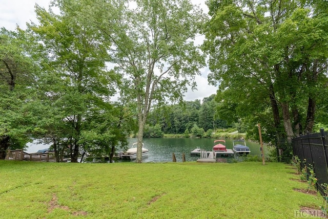 view of yard featuring a dock and a water view