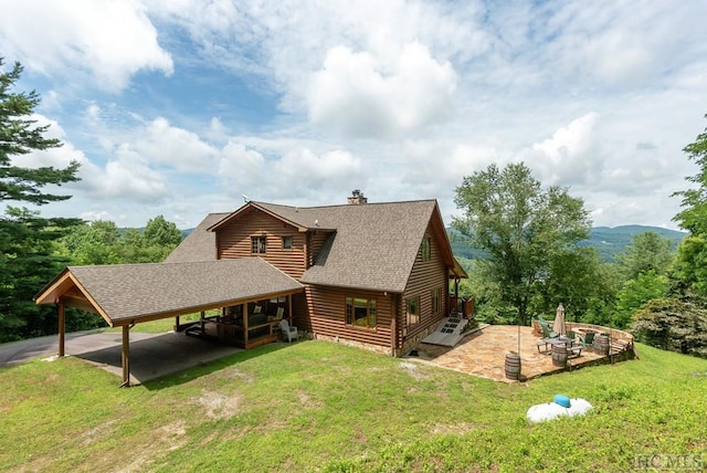 back of property featuring a yard and a patio area