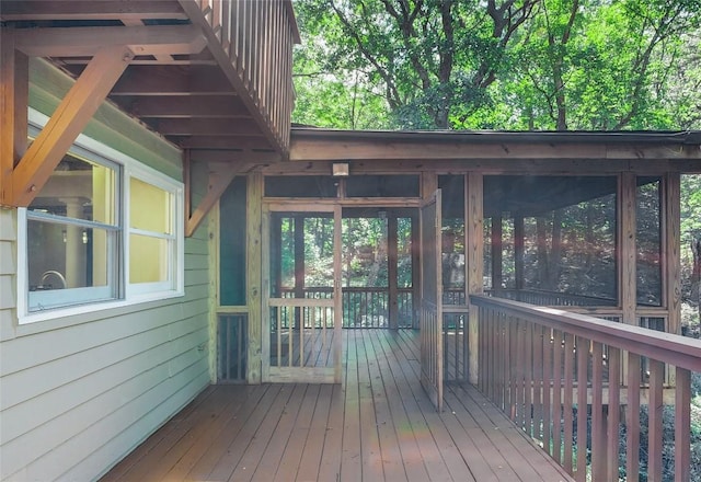 wooden deck featuring a sunroom