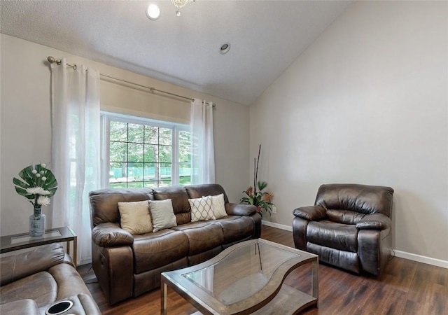 living area featuring baseboards, vaulted ceiling, and wood finished floors