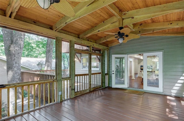unfurnished sunroom with a ceiling fan and plenty of natural light