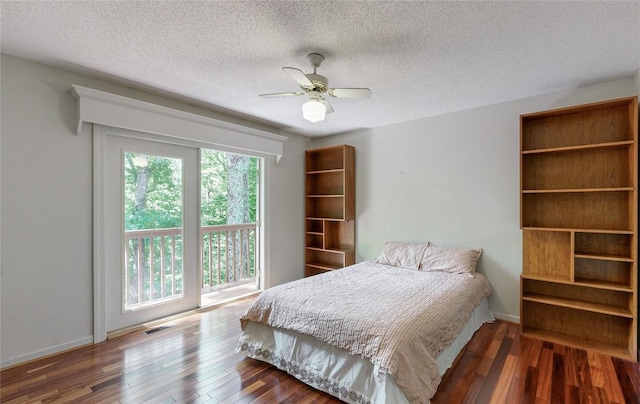 bedroom with visible vents, a ceiling fan, wood finished floors, and a textured ceiling