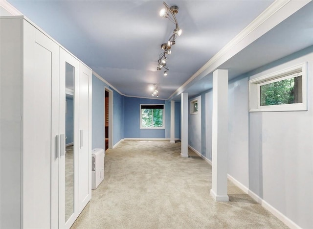 corridor featuring light colored carpet, baseboards, and ornamental molding