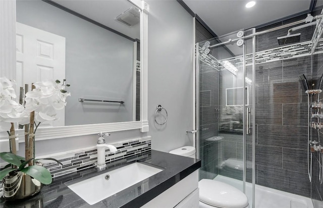 full bathroom with toilet, vanity, a shower stall, and visible vents