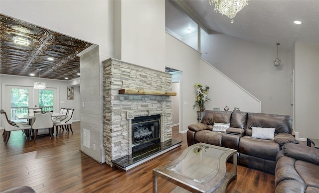 living room with baseboards, a fireplace, recessed lighting, wood finished floors, and high vaulted ceiling