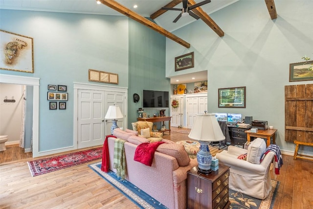 226 Sky Lake Dr, Highlands, NC 28741 - living room featuring high vaulted ceiling, beamed ceiling, wood finished floors, baseboards, and a ceiling fan