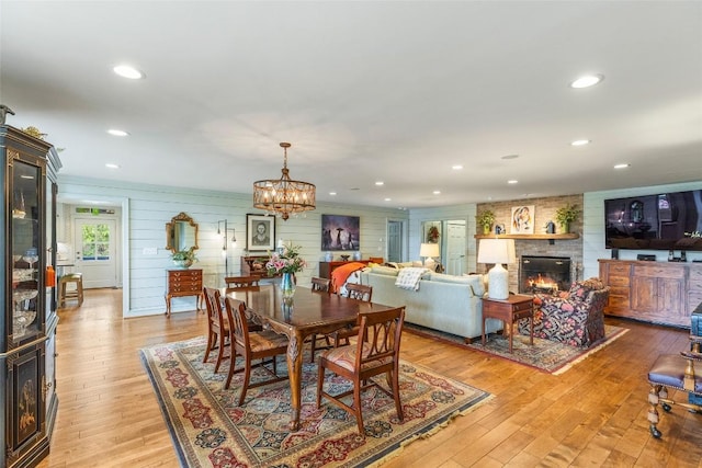 226 Sky Lake Dr, Highlands, NC 28741 - dining area featuring a large fireplace, light wood-style floors, a chandelier, and recessed lighting