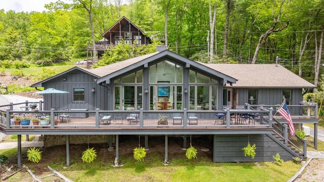 226 Sky Lake Dr, Highlands, NC 28741 - back of house with board and batten siding, a deck, a view of trees, roof with shingles, and stairs