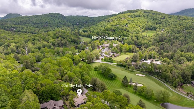 226 Sky Lake Dr, Highlands, NC 28741 - bird's eye view of a heavily wooded area, a mountain backdrop, and a golf club