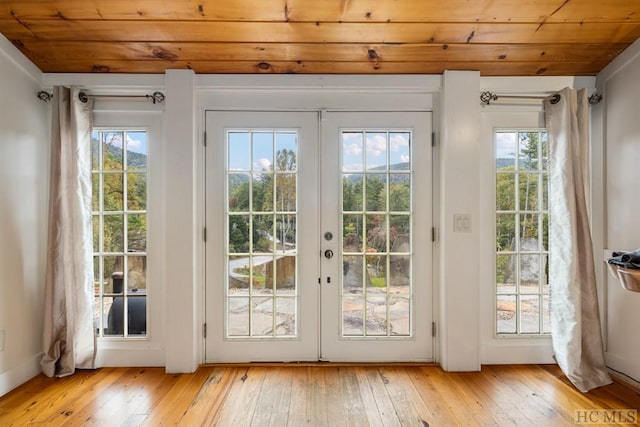 entryway with french doors, wood ceiling, and light hardwood / wood-style flooring