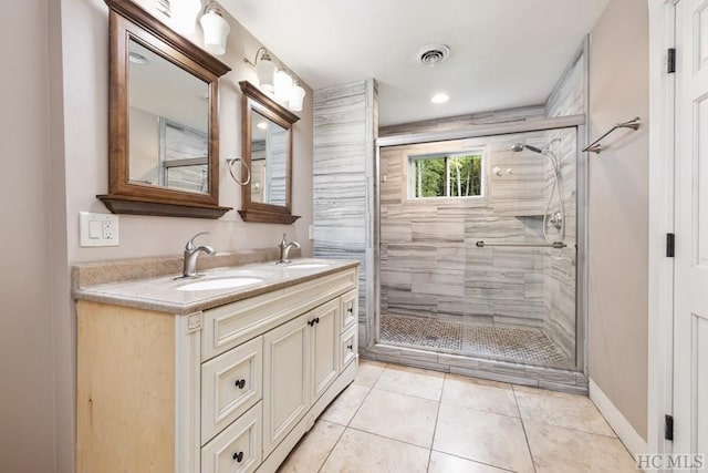 bathroom featuring a shower with door, vanity, and tile patterned flooring