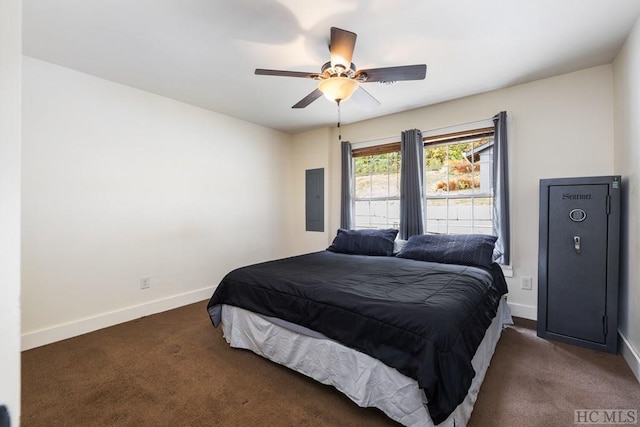 bedroom featuring ceiling fan, electric panel, and dark colored carpet