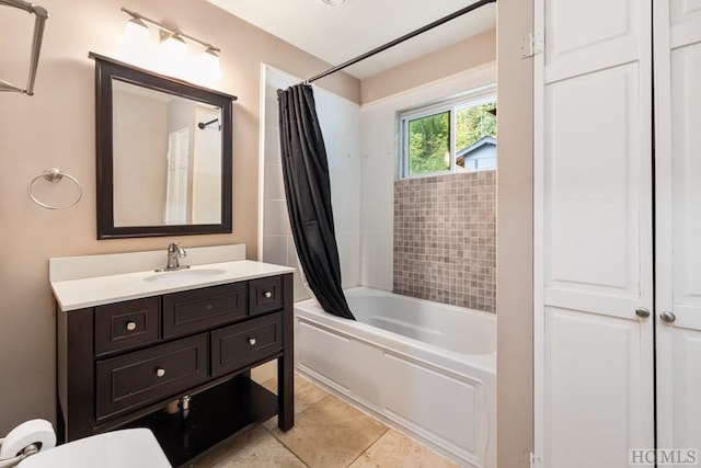 bathroom with shower / tub combo, vanity, and tile patterned flooring