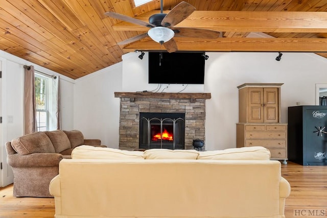 living room with vaulted ceiling, wood ceiling, a fireplace, and light hardwood / wood-style floors