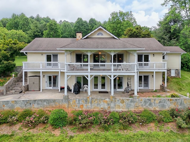 70 Fairway Ln, Sky Valley, GA 30537 - back of property featuring french doors, a patio area, a chimney, and a shingled roof
