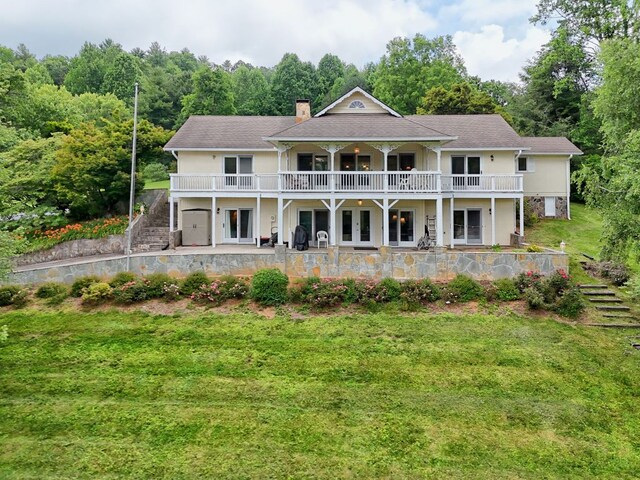 70 Fairway Ln, Sky Valley, GA 30537 - rear view of house featuring stairway, a chimney, a patio area, a yard, and stucco siding