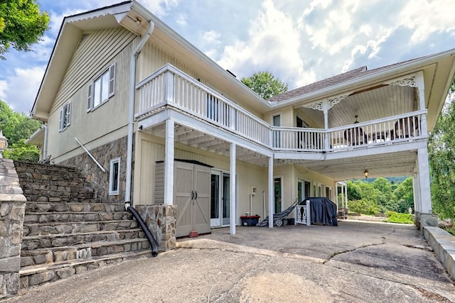 70 Fairway Ln, Sky Valley, GA 30537 - rear view of house with stone siding, concrete driveway, and a carport
