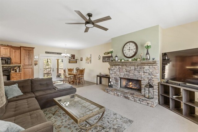 210 Triple Fork Rd, Cullowhee, NC 28723 - living room with ceiling fan, carpet flooring, a fireplace, a chandelier, and french doors