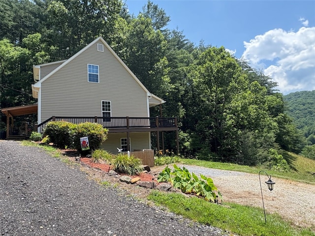 210 Triple Fork Rd, Cullowhee, NC 28723 - view of side of property featuring a deck, a wooded view, and driveway