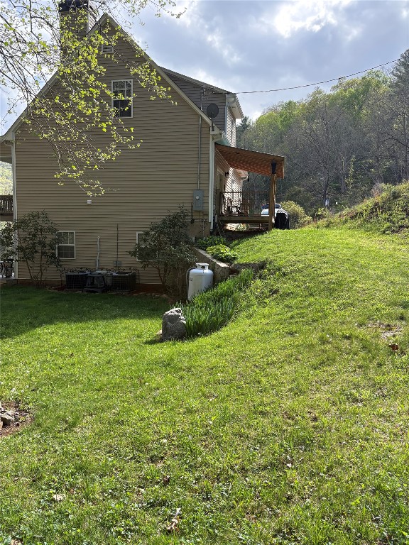 210 Triple Fork Rd, Cullowhee, NC 28723 - view of property exterior with a lawn and a chimney