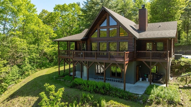 1318 Shortoff Rd, Highlands, NC 28741 - back of house with log exterior, a patio area, a chimney, a lawn, and a deck