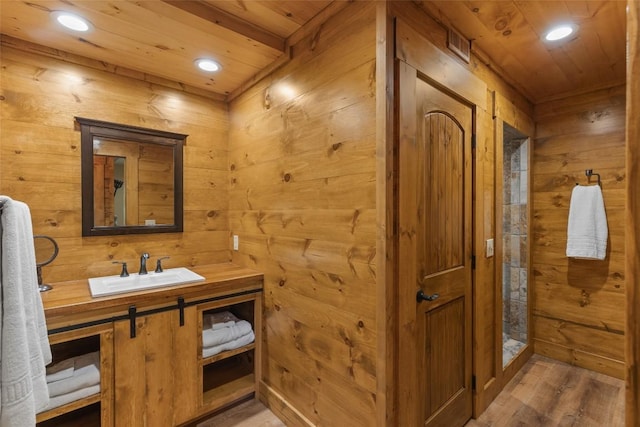1318 Shortoff Rd, Highlands, NC 28741 - bathroom with wood ceiling, wood finished floors, wood walls, recessed lighting, and vanity